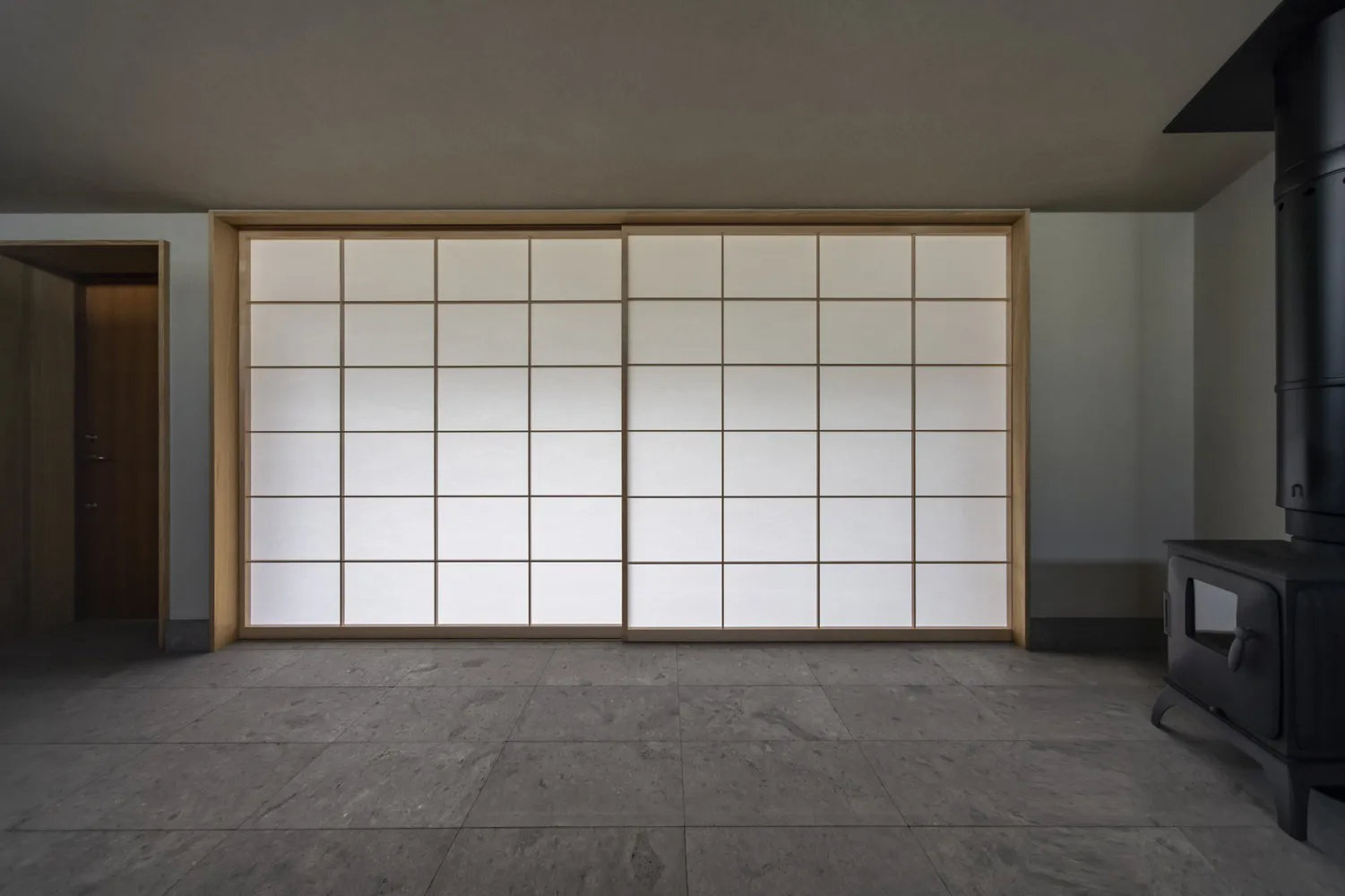 A modern interior featuring a large sliding glass door.