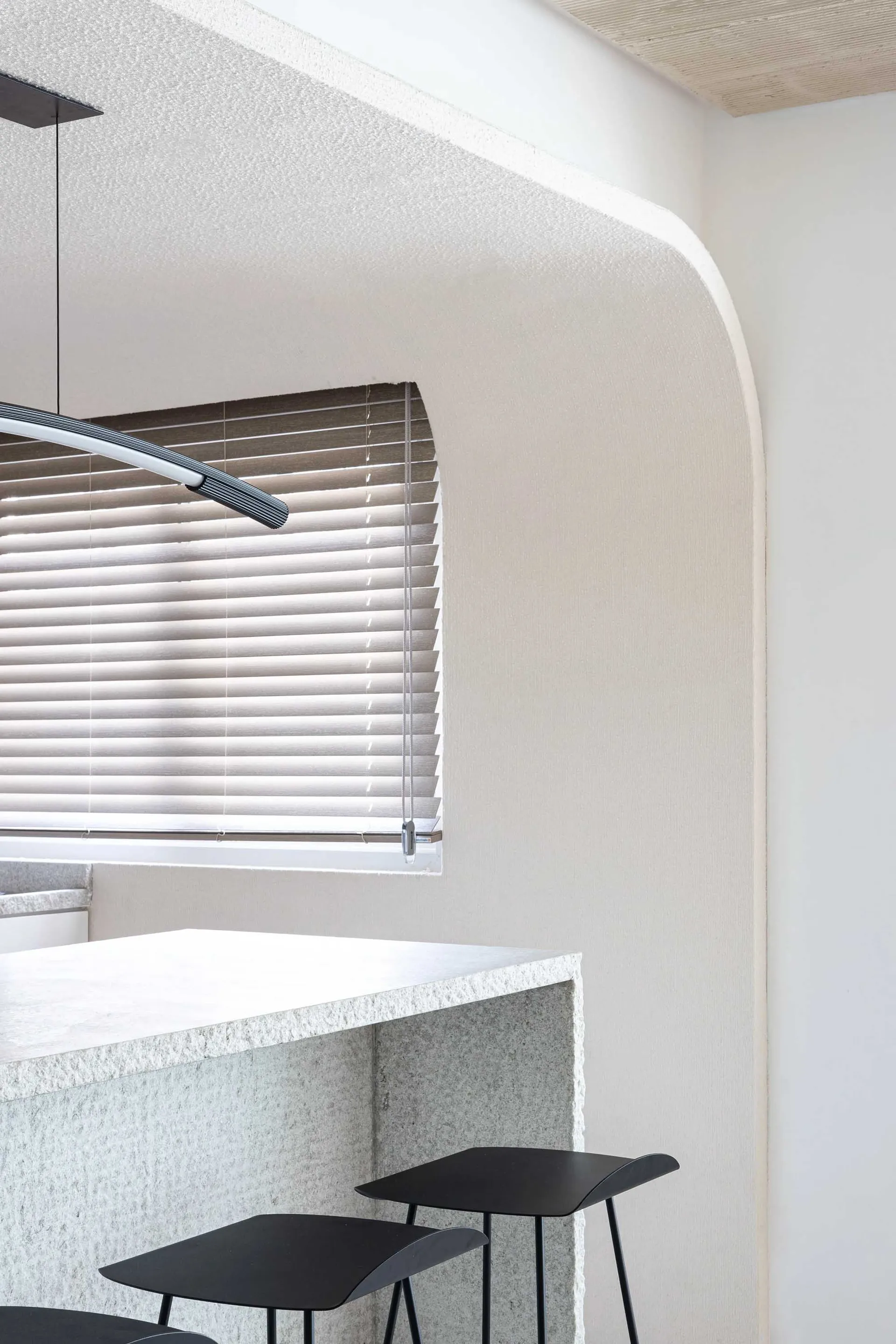 A minimalist interior design featuring polished concrete walls and a clean, modern aesthetic.