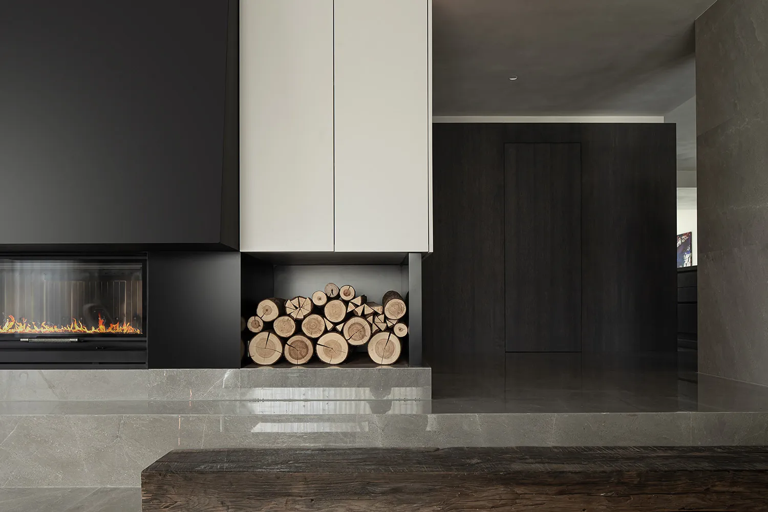 Modern minimalist living room with a fireplace and concrete floor and walls