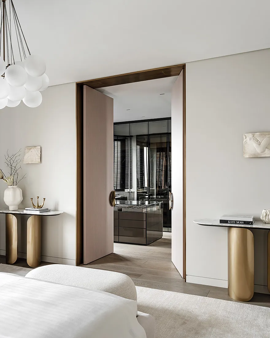 A minimalist bedroom with neutral tones, wooden floors, and marble accents.