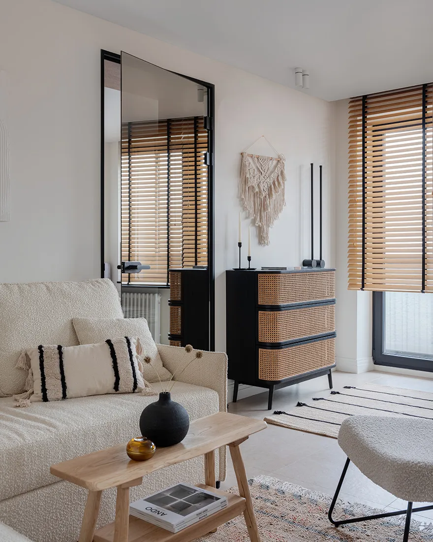 A minimalist living room featuring neutral-toned furniture and decor.
