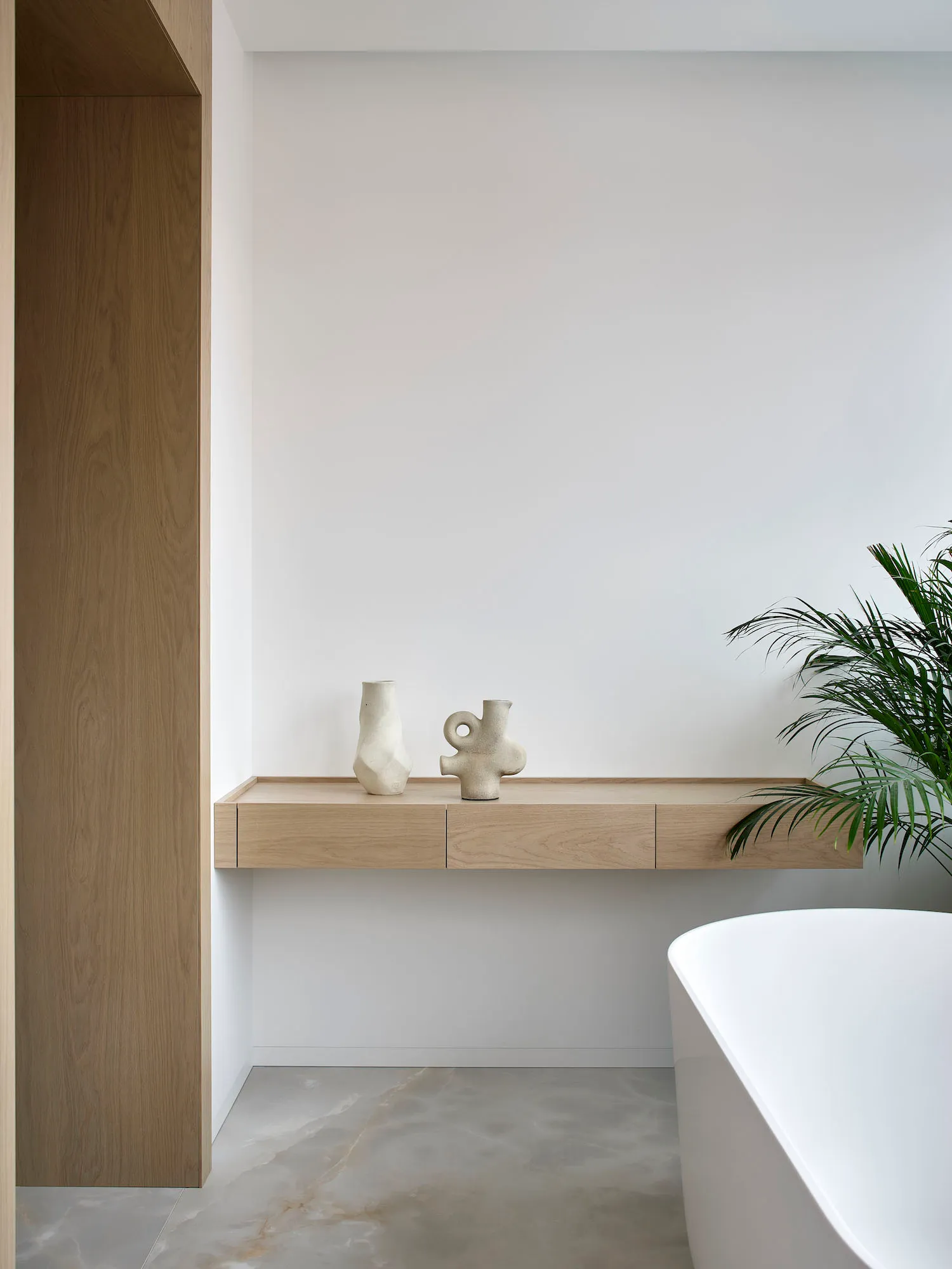 Minimalist residential bathroom with concrete and wood elements