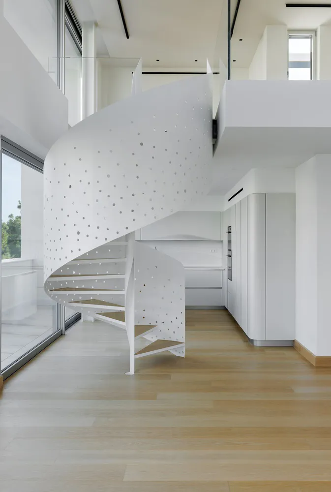 A modern white perforated metal staircase interior design