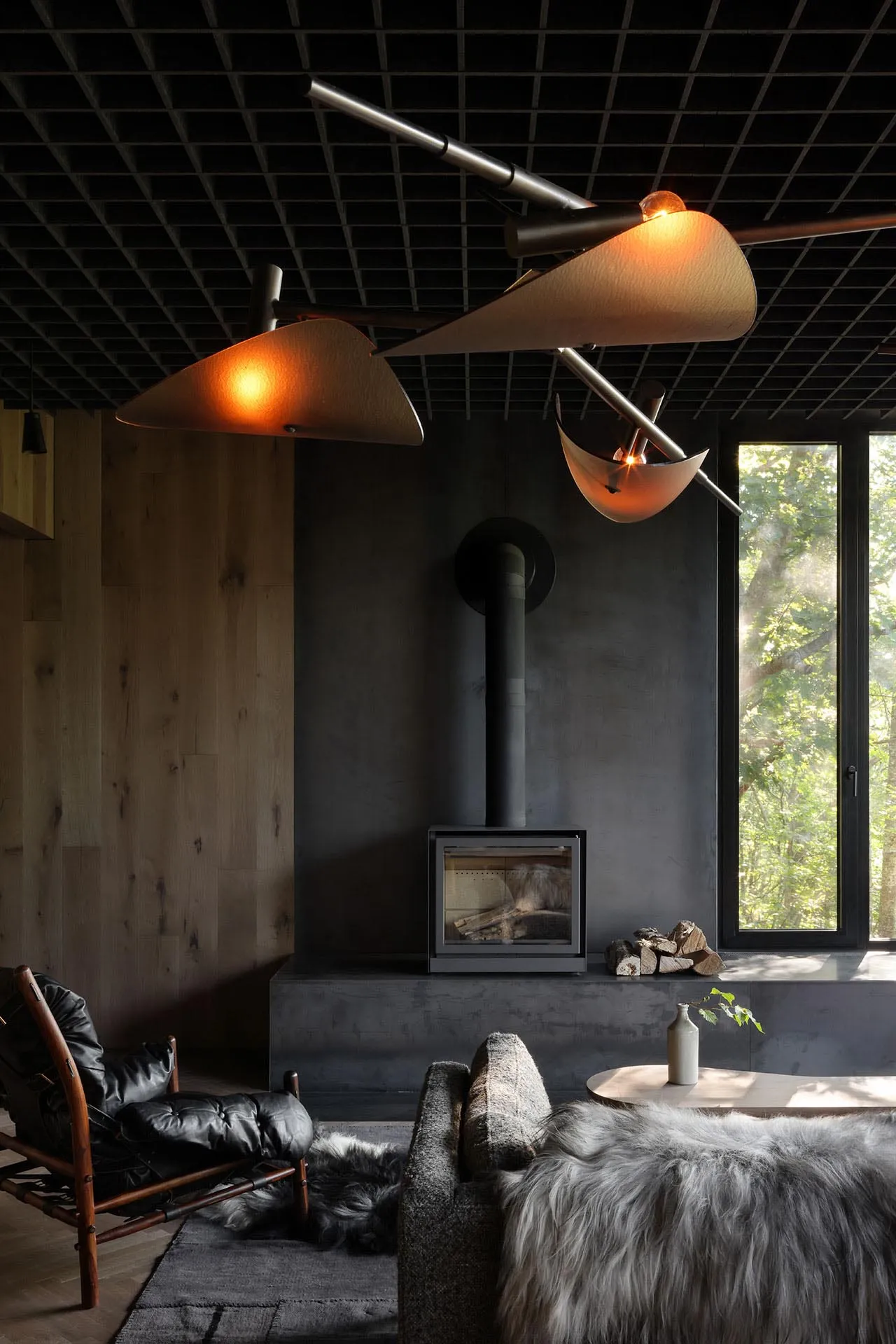 Industrial-style living room featuring concrete surfaces, minimalistic design, and a cozy fireplace.