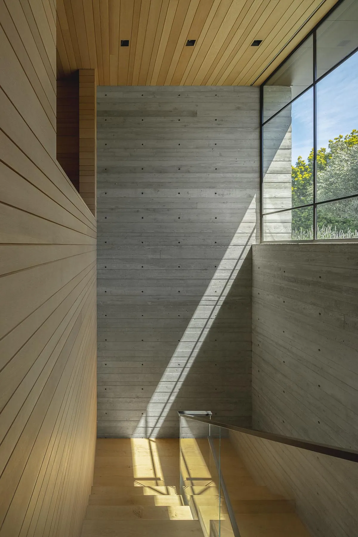 Modern interior design featuring concrete and wooden walls and floors.