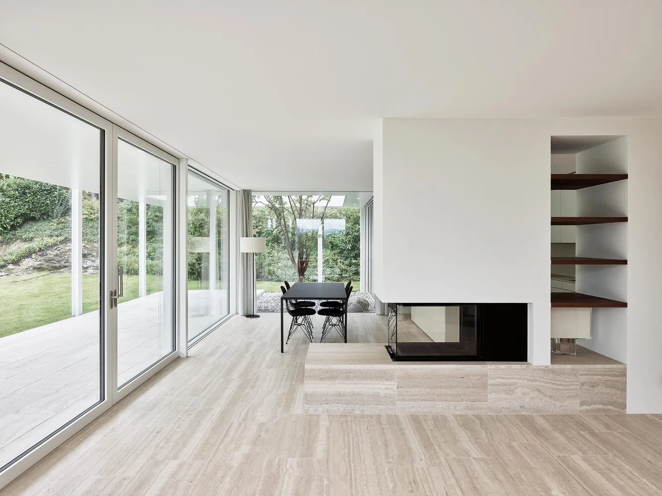 Modern minimalist living room featuring marble flooring and contemporary furniture.