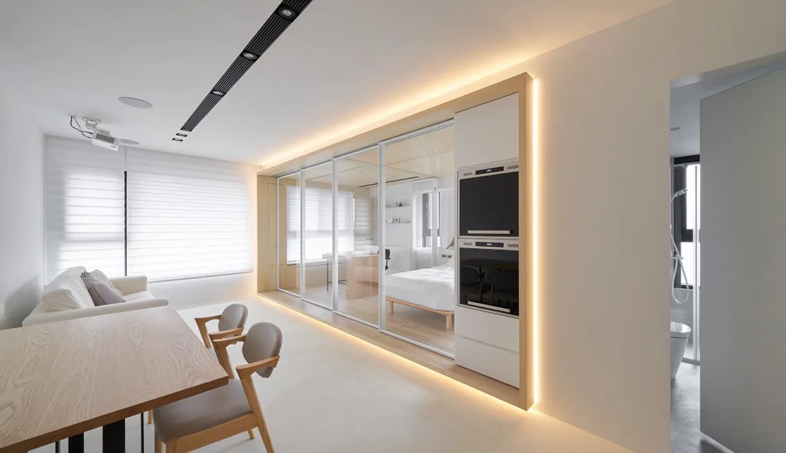Modern residential living room with white matte upholstery, featuring sleek furniture and minimalistic design.