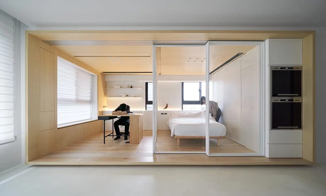 A minimalist apartment with white walls, natural pine, and modern lighting features.