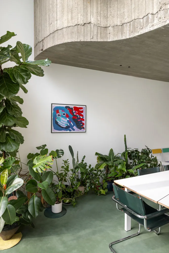 混凝土牆面與綠色植物的餐廳空間,搭配混凝土吊頂