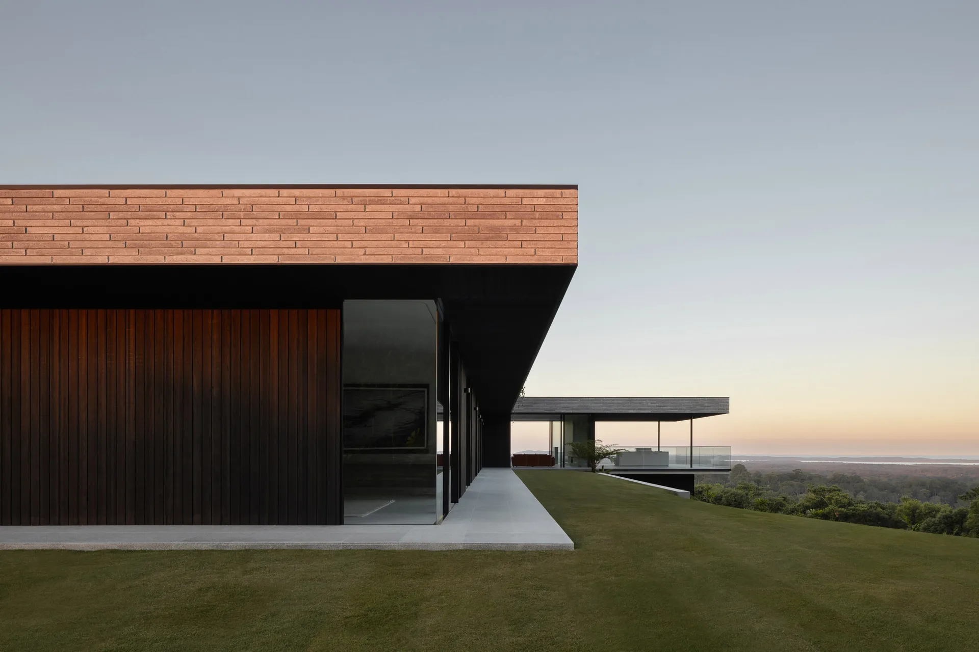 Modern house with wooden exterior and large glass windows