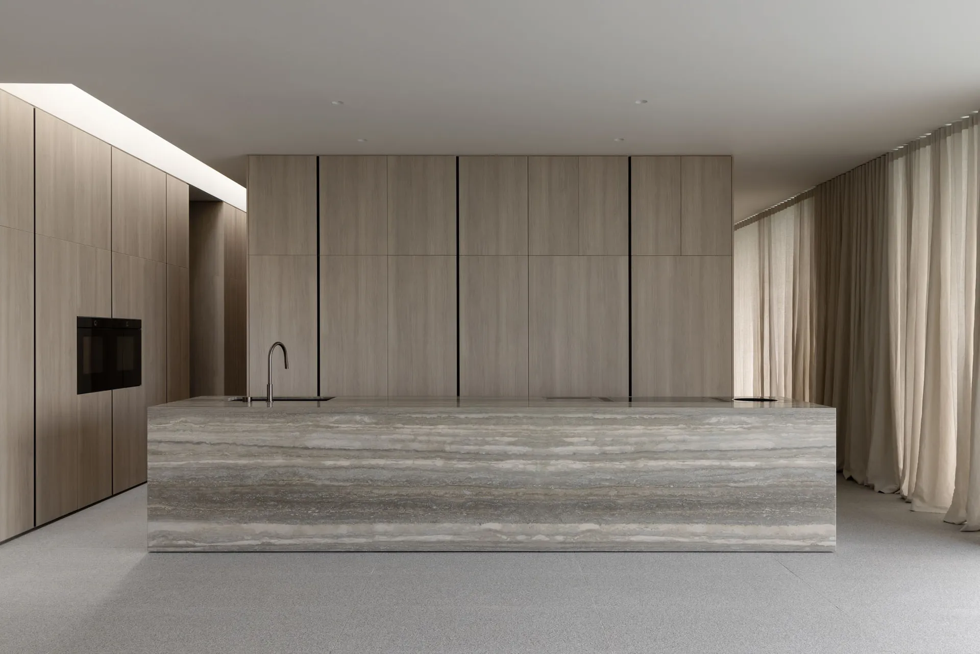 Modern kitchen with marble countertops and integrated appliances