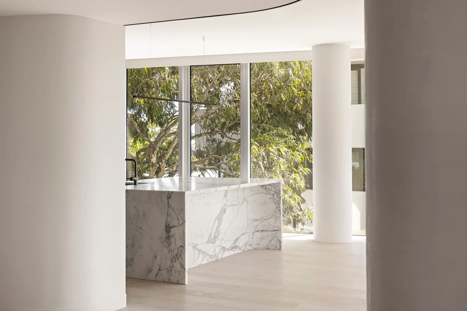 Modern residential kitchen featuring marble countertops and floors.