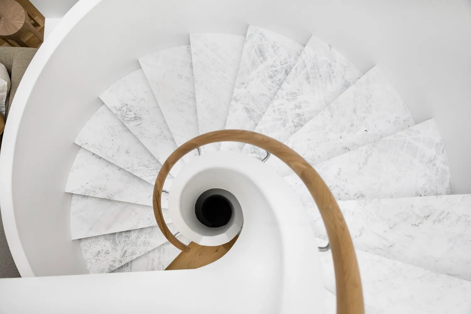 A spiral staircase made of white marble.