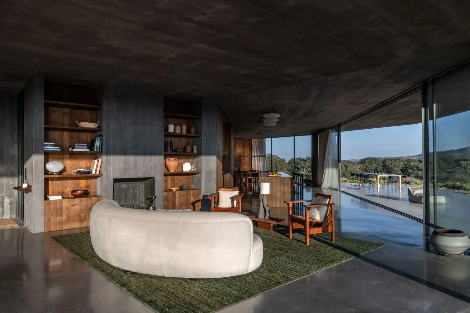 A minimalist residential interior with concrete and wooden elements.