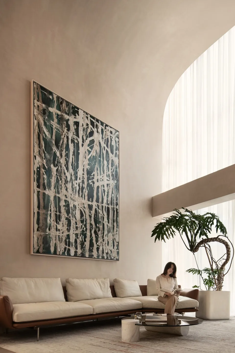 A contemporary living room with metallic furniture and large windows.
