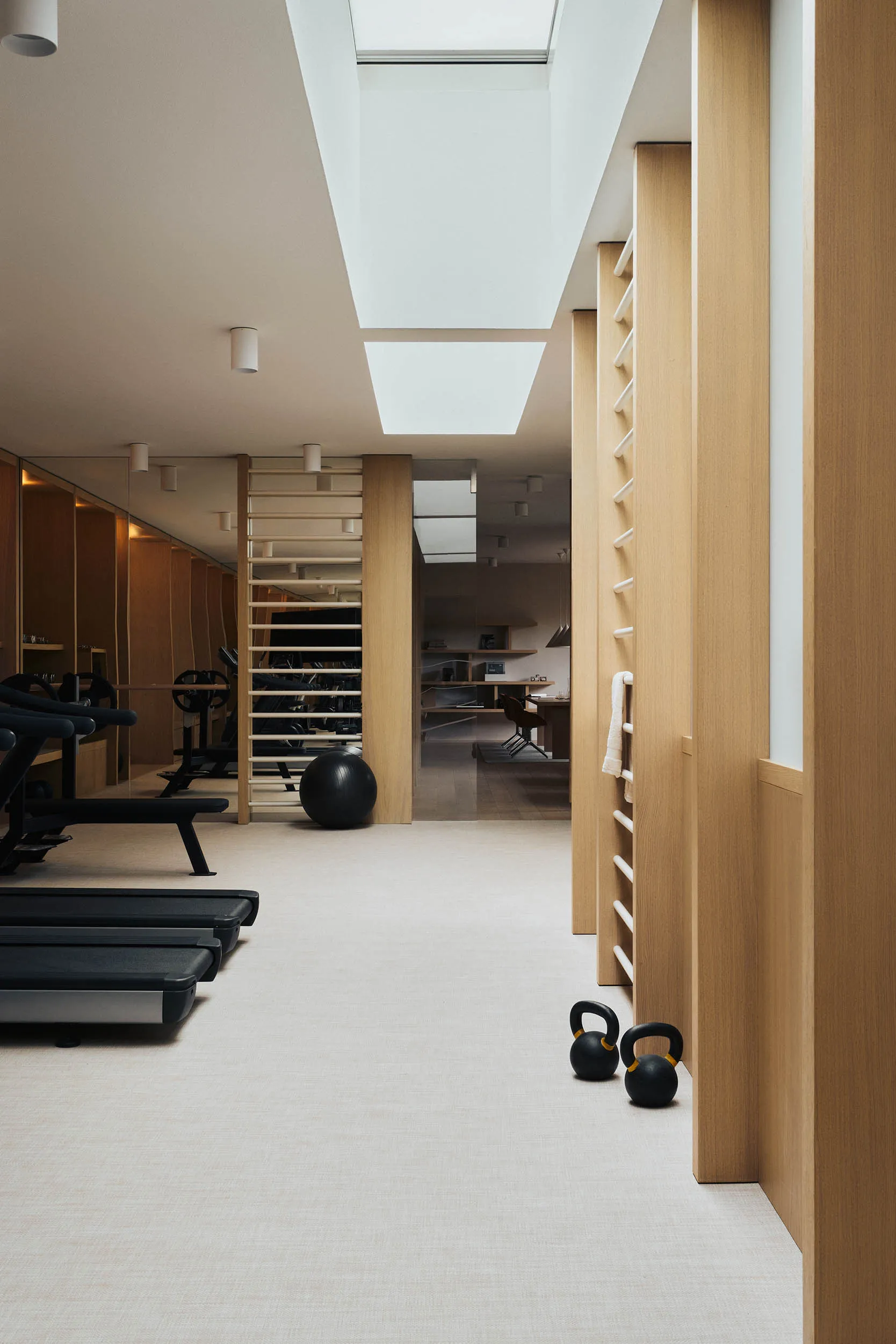 A modern minimalist gymnasium with wooden elements and minimalistic design features.