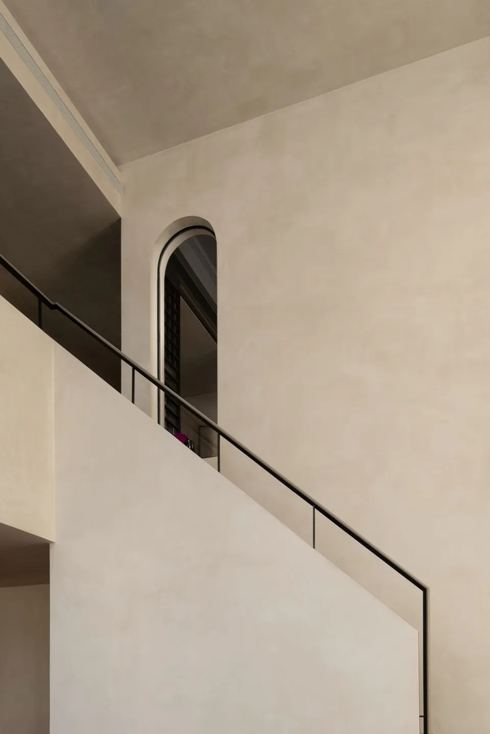 A minimalist staircase constructed from concrete, featuring sleek lines and a minimalist design.