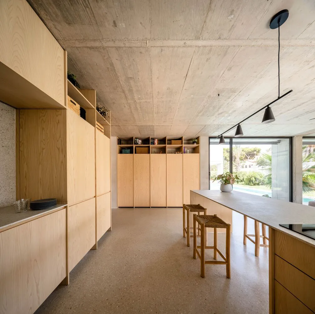 Minimalist residential kitchen featuring wooden cabinets and open shelves.