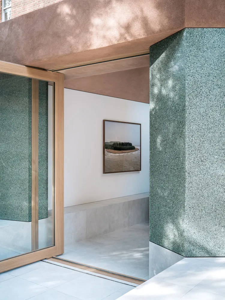Modern entryway featuring a terrazzo flooring and minimalist design.