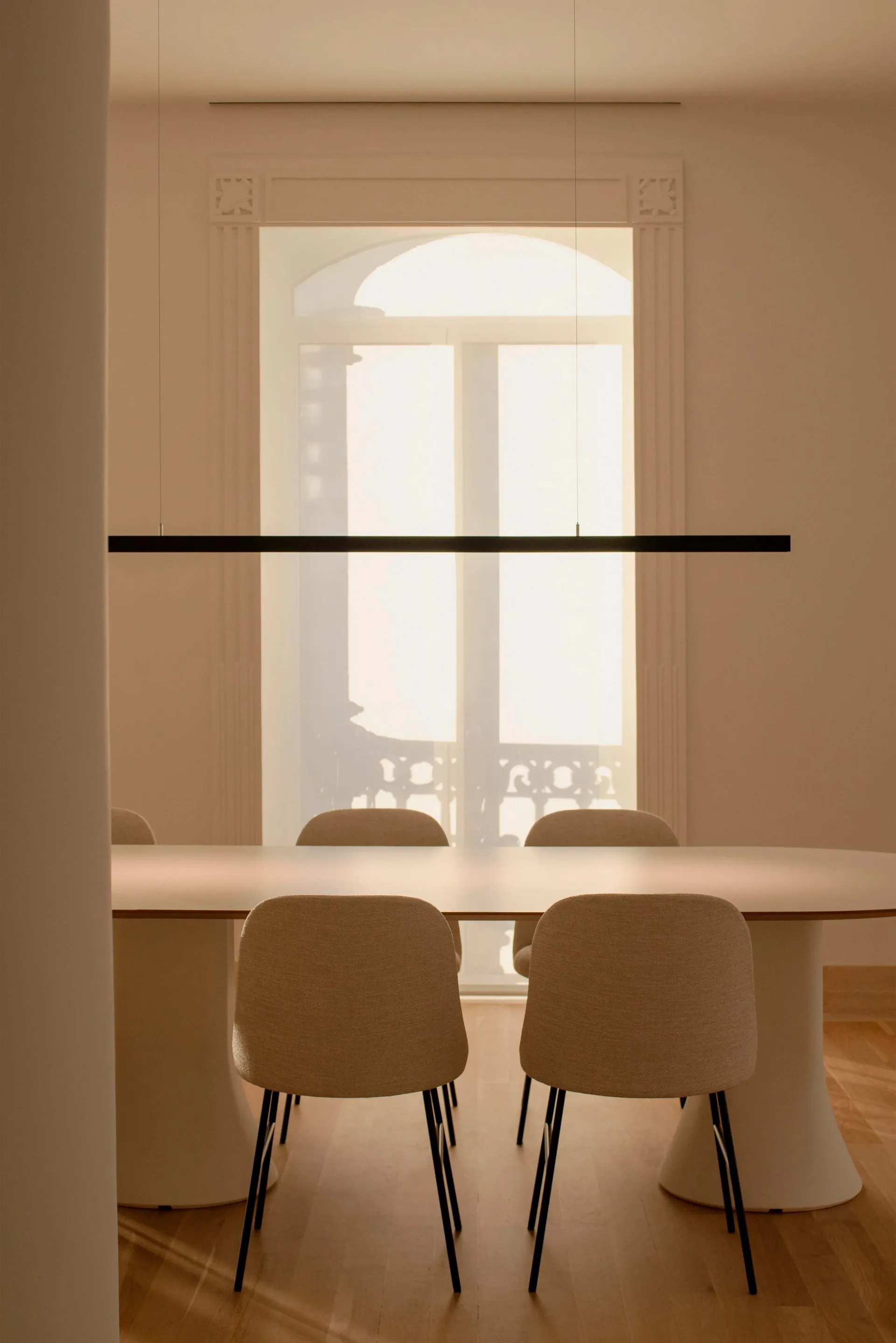 Modern minimalist dining room with clean lines, neutral tones, and a sleek, contemporary table and chairs.