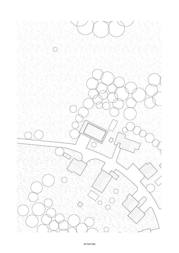 Detailed architectural site plan with white paper outlines representing buildings, trees, and other elements.