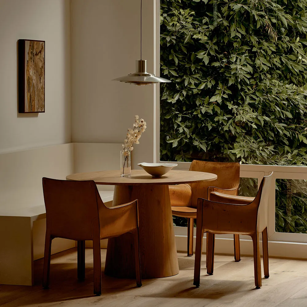 Industrial-style dining table and chairs in a residential setting.