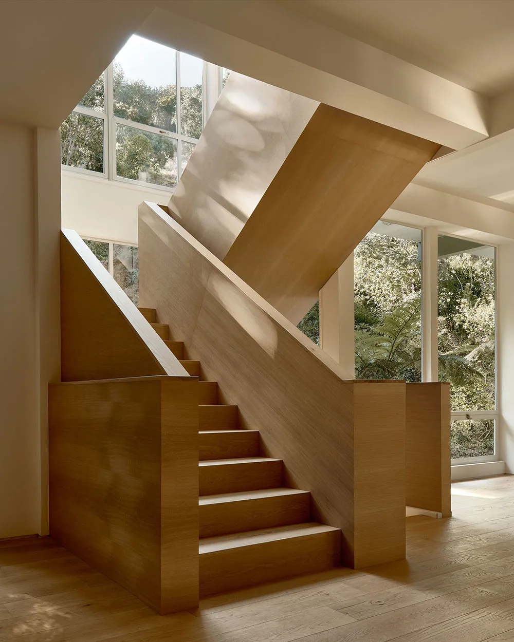 Modern interior design featuring a staircase with wooden railings and steps.