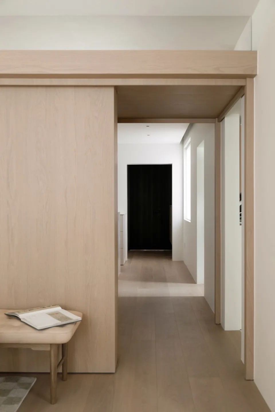 Modern minimalist interior design featuring light wood flooring and furniture