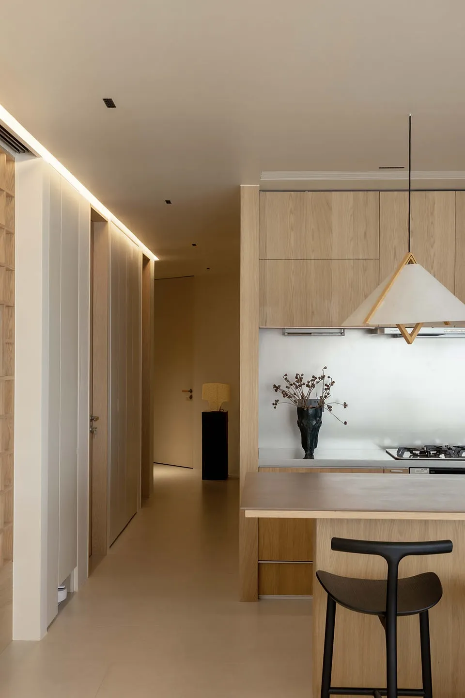Modern kitchen with wooden paneling and a minimalist design.
