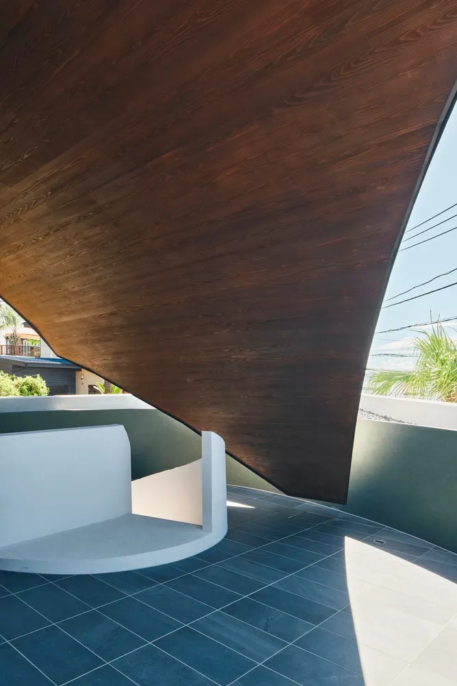 A minimalist interior design featuring a wooden ceiling and floor tiles.