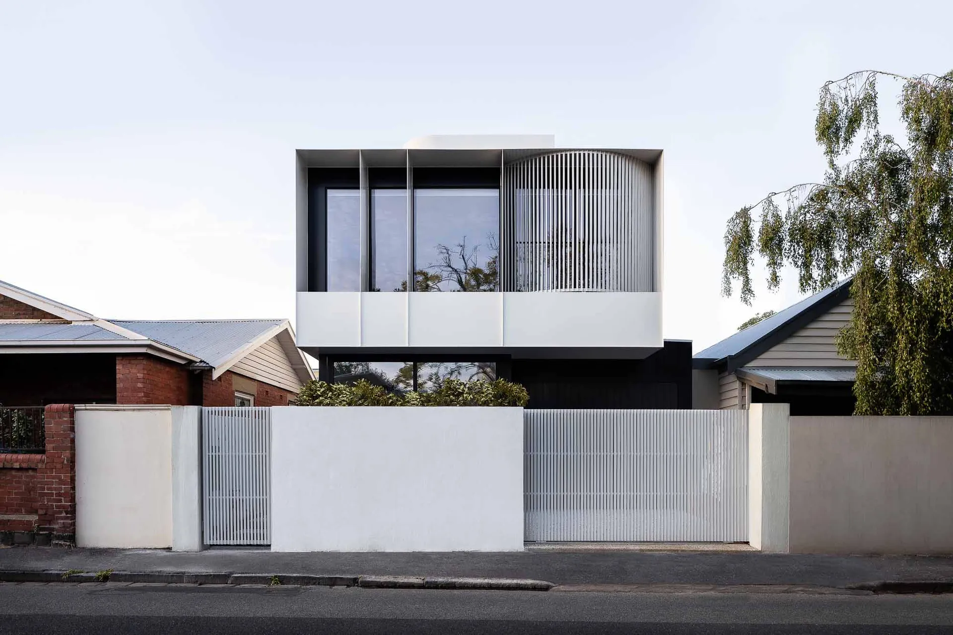 Modern, minimalist urban house with concrete and glass exterior.
