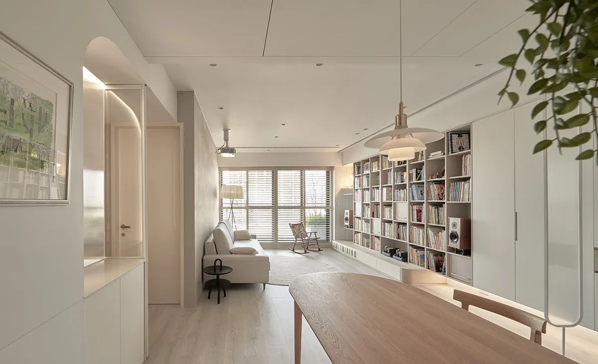 Modern living room featuring wooden furniture and a large bookshelf.