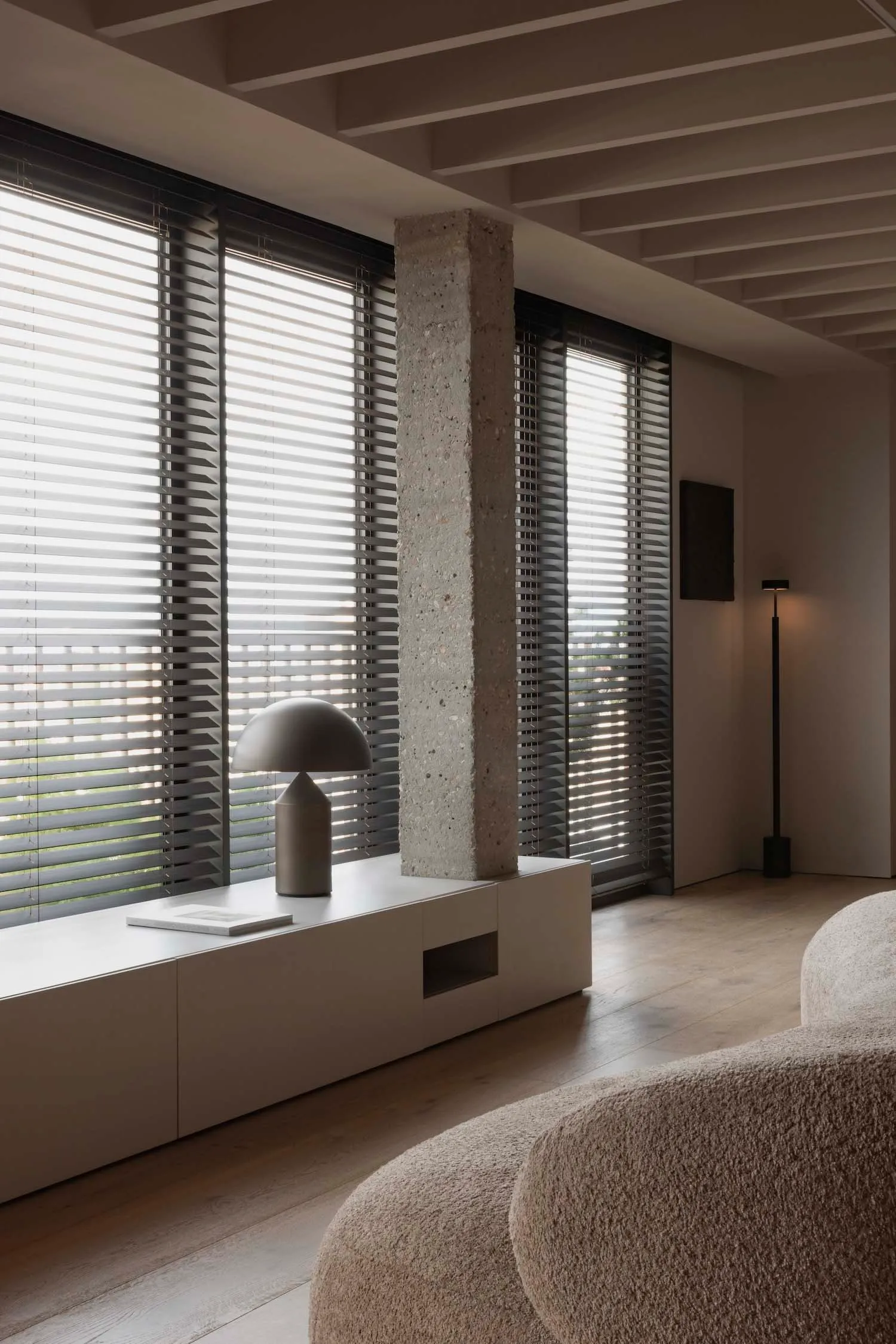 A modern living room featuring concrete elements and a minimalist design.