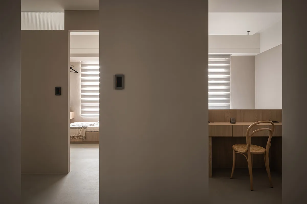 A minimalist bedroom with neutral tones and modern furniture.