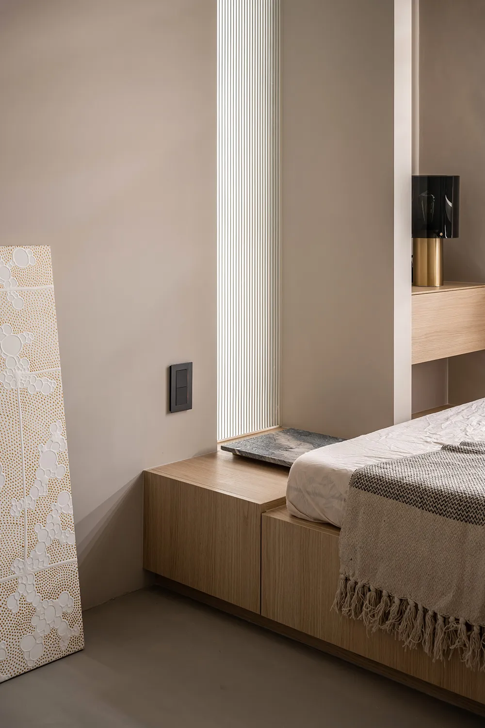 A minimalist bedroom featuring wooden furniture with a modern design.