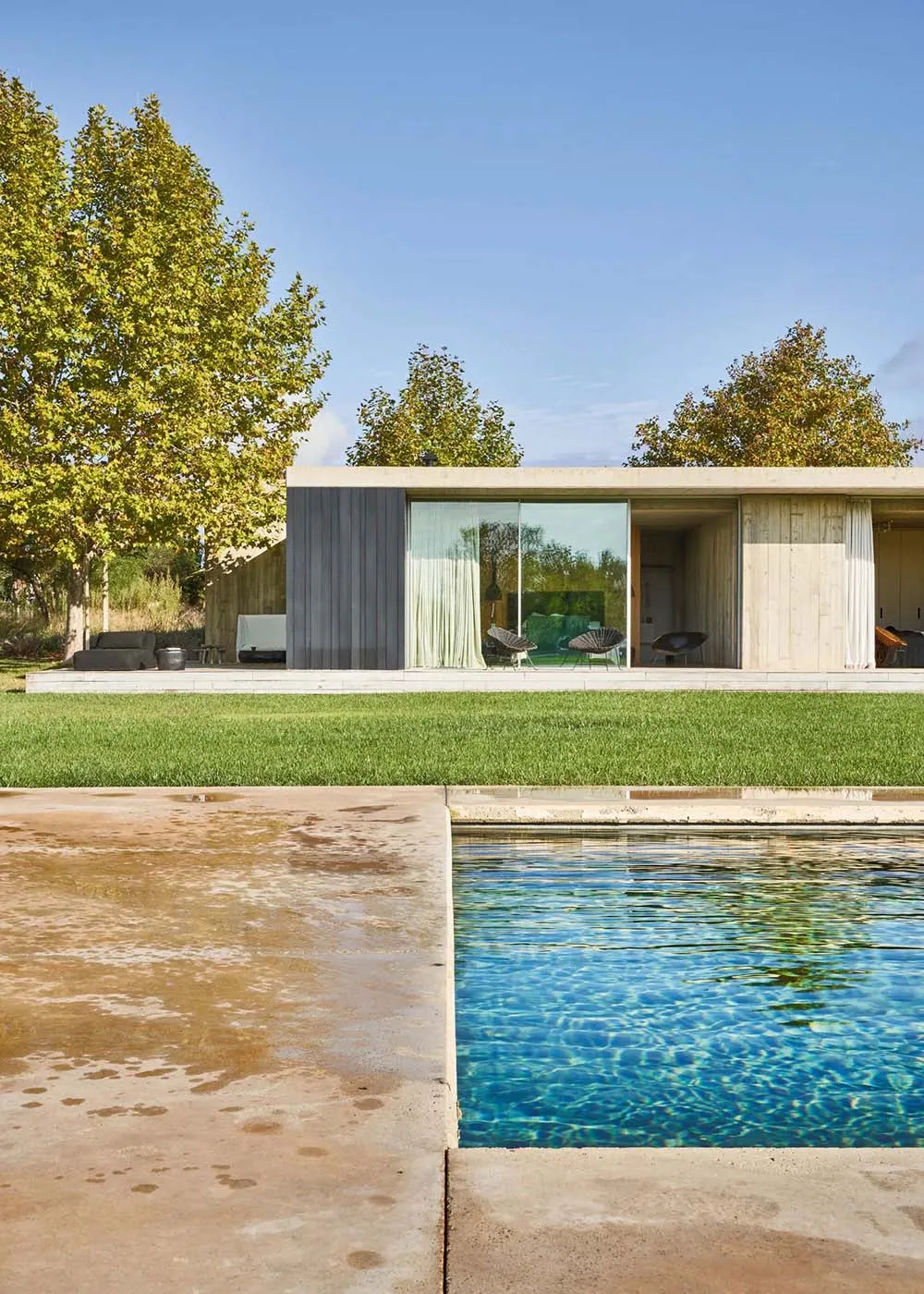 Modern minimalist residential architecture featuring clean lines and a large glass window.