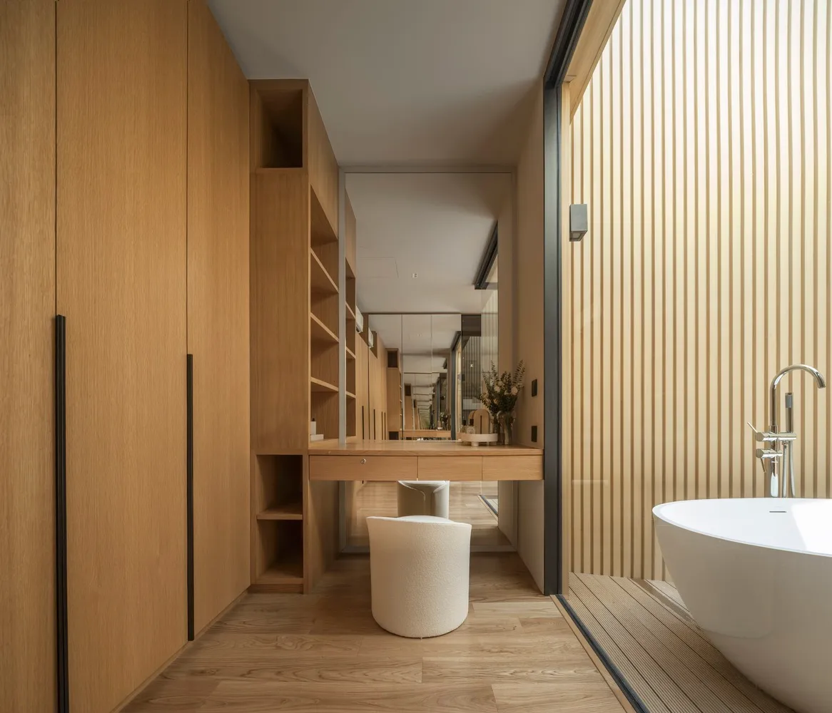 A minimalist bathroom featuring sleek, modern design elements with a focus on wood materials.