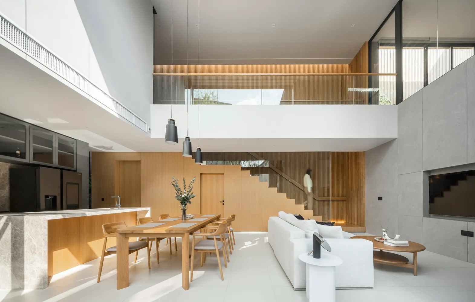 A modern residential interior featuring minimalist design and use of wood, marble, and glass materials.