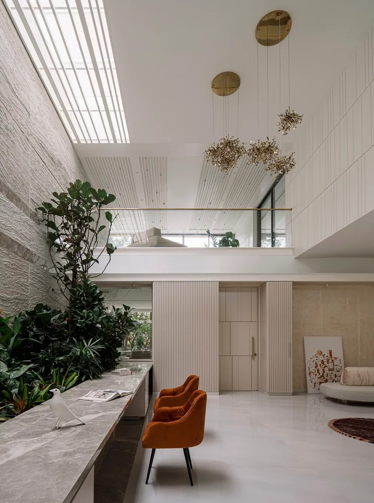 A minimalist living room featuring concrete, marble, and wooden elements.