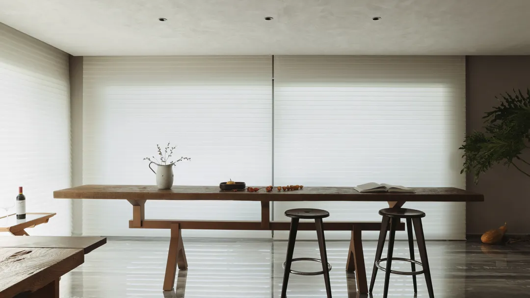 Modern minimalist living area with wooden furniture and glass windows