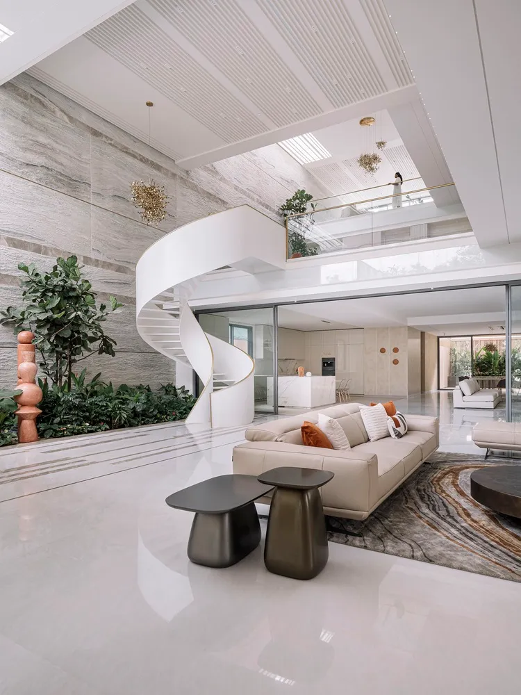 Modern living room with concrete, glass, and marble elements.