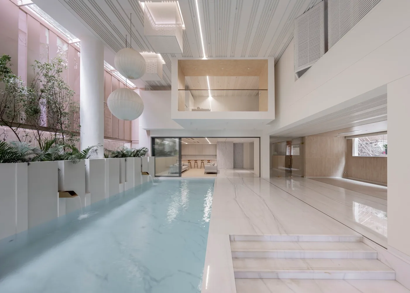 Modern living room with a glass pool and glass walls