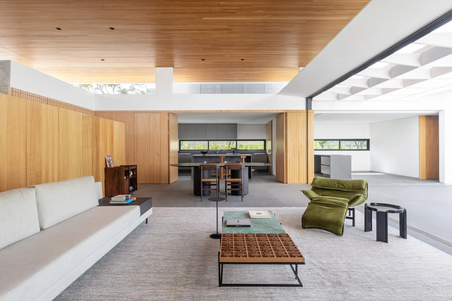 Minimalist living room with wood accents and modern furniture.