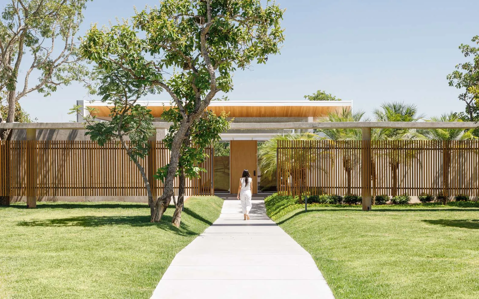 A modern exterior residential home featuring wood and concrete materials.