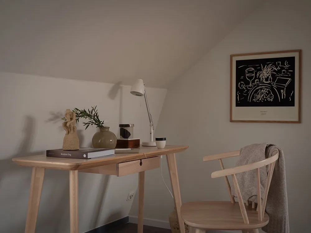 A simple, modern home office features wooden furniture and minimalist design elements, with a focus on functionality and styl