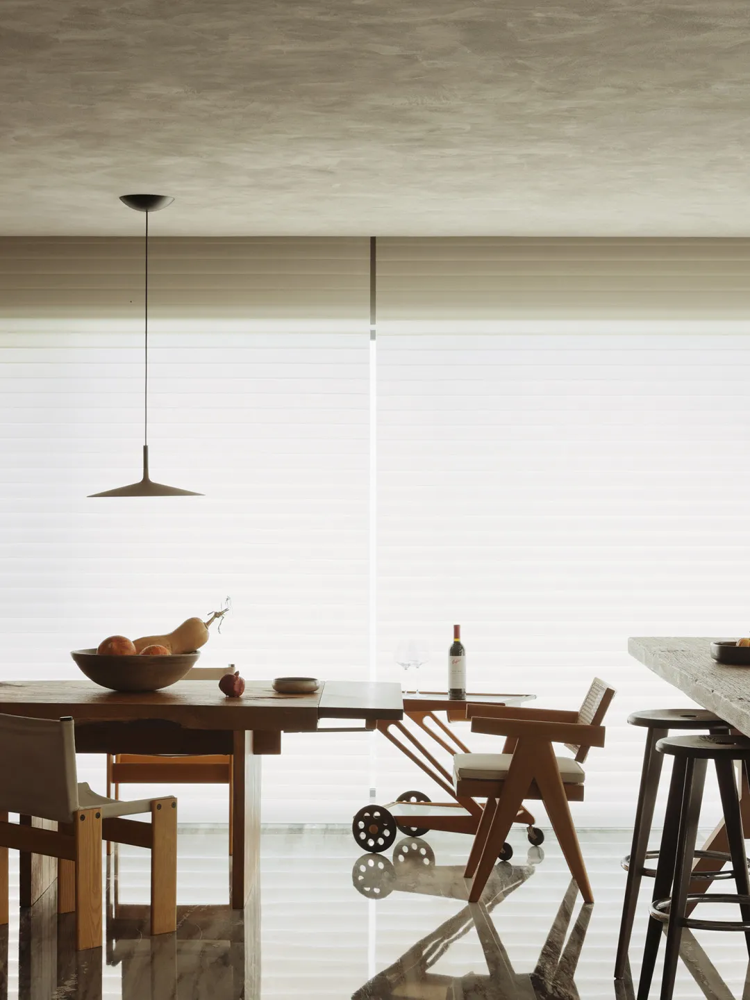 A modern dining room with wooden furniture and minimalistic decor.