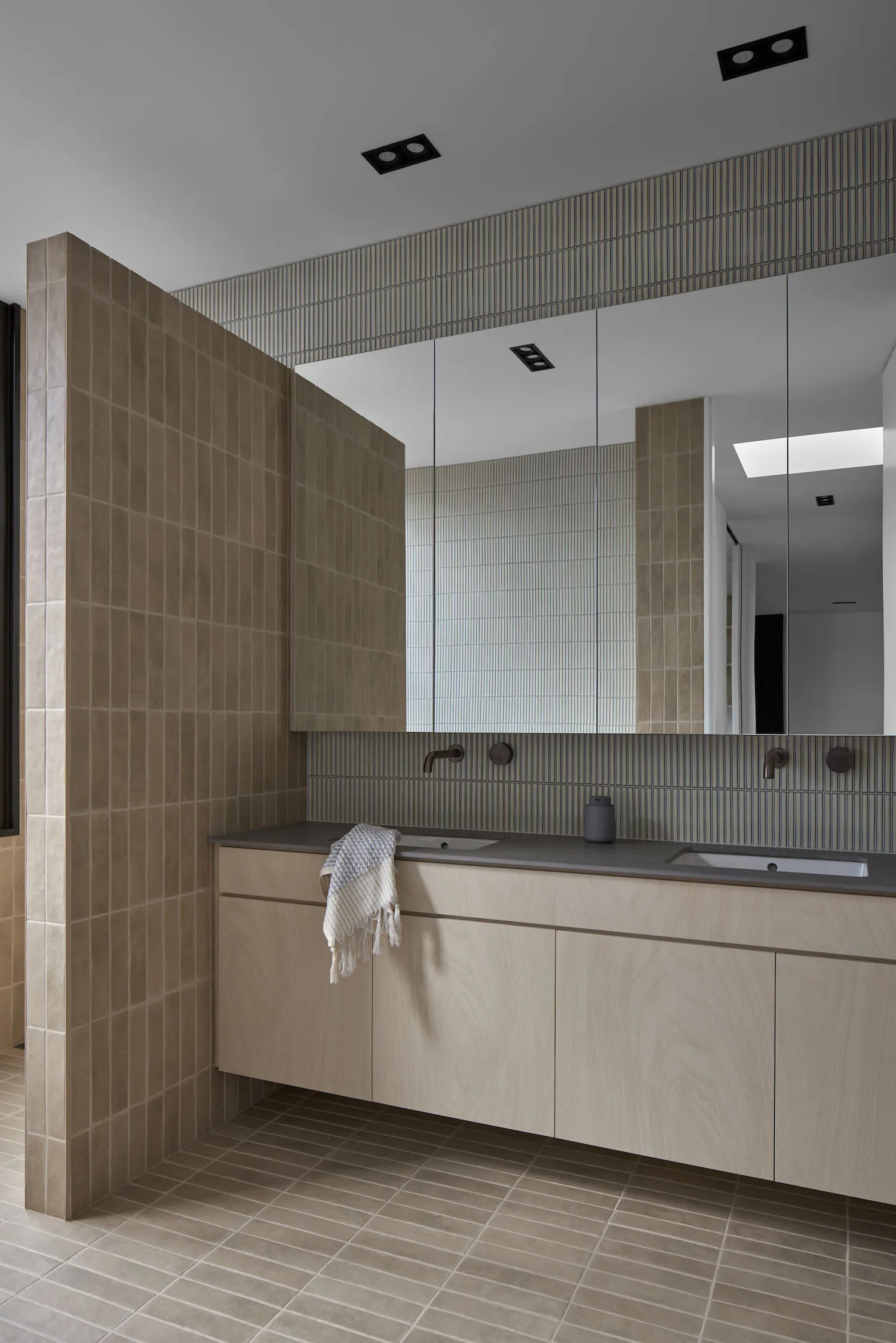Modern minimalist bathroom featuring tile and concrete surfaces.