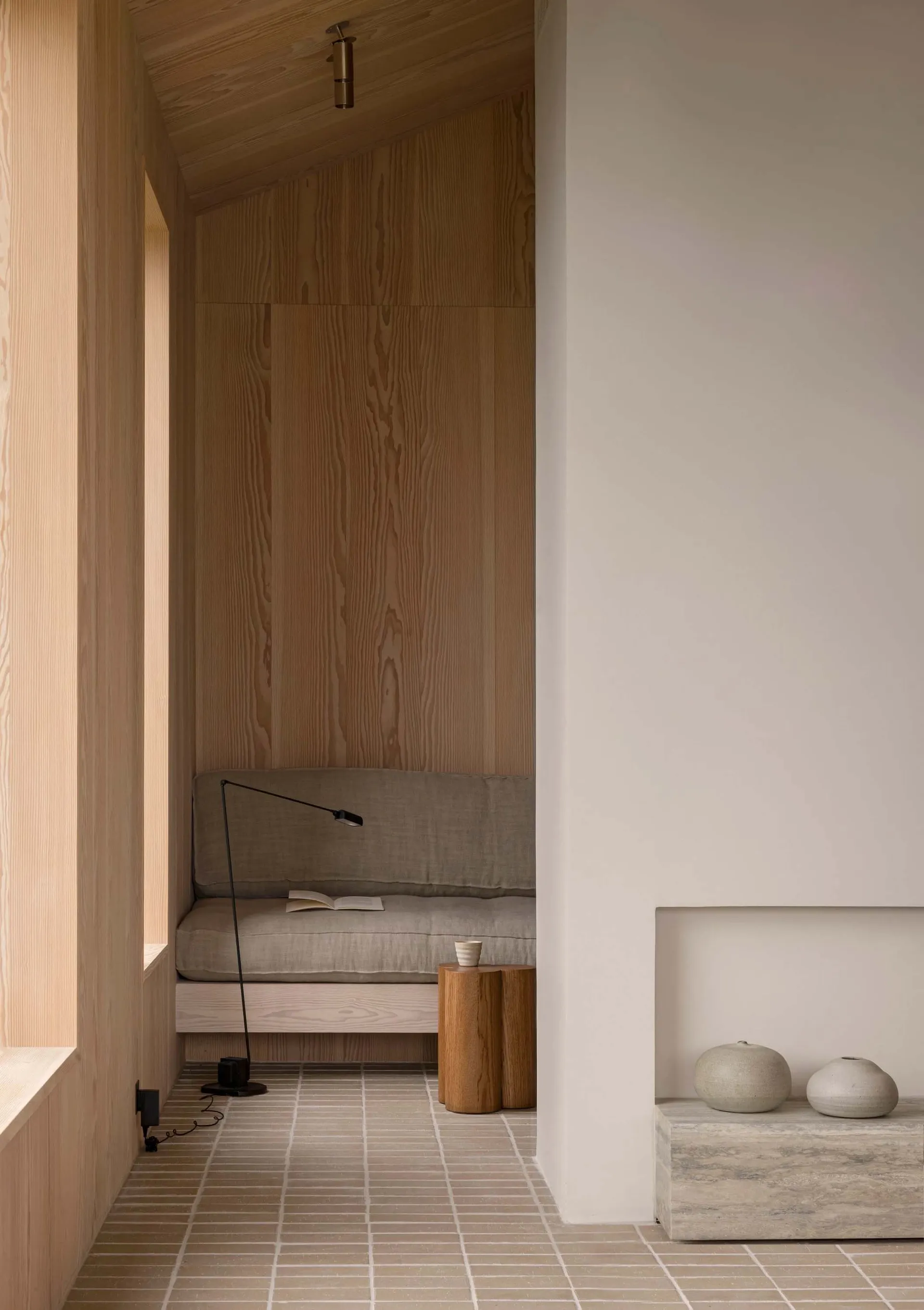 A minimalist living room with wooden accents and a cozy seating area.