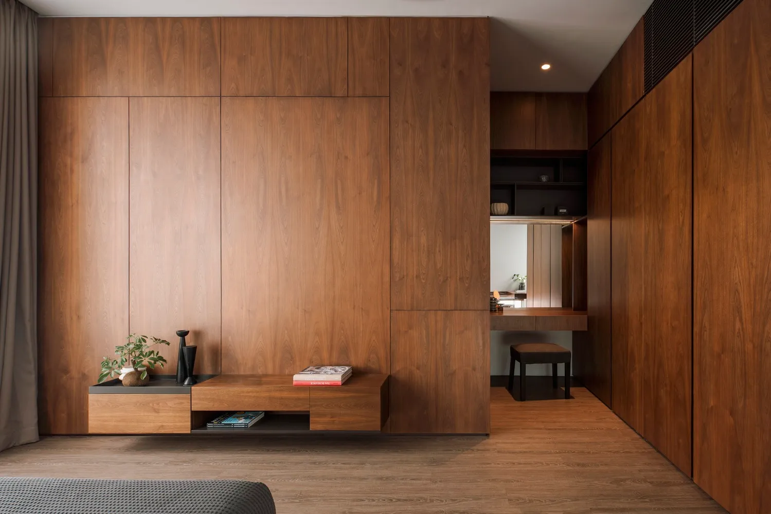 A minimalist bedroom with wooden walls, floors, and furniture.