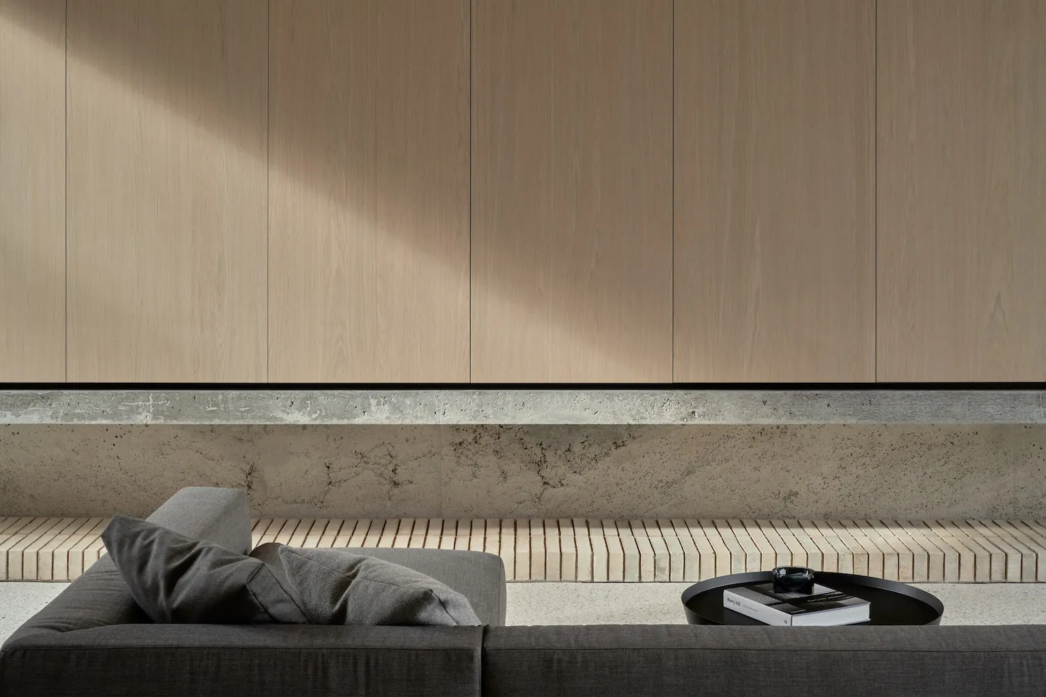 Minimalist living room featuring a concrete and wood interior design.